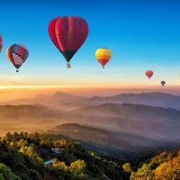 Colorful,Hot,Air,Balloons,Flying,Over,Mountain,At,Dot,Inthanon